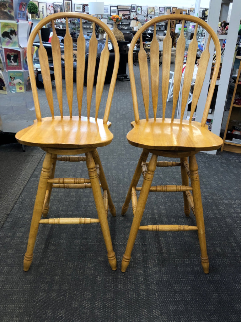 2 SWIVEL OAK BAR STOOLS.