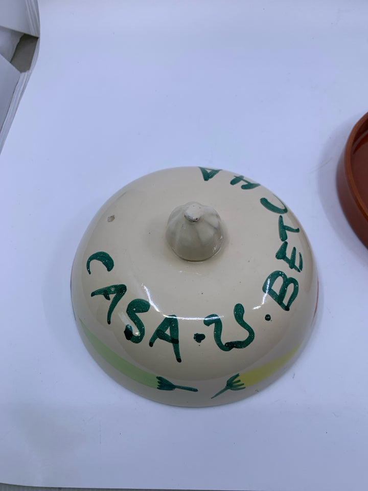 TERRA COTTA TORTILLA WARMER W/ PEPPERS ON IT.