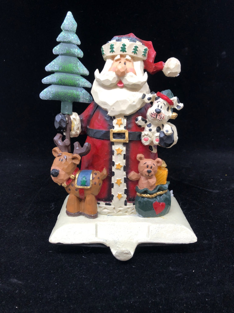 NIB WOOD CARVED SANTA W/PUPPIES STOCKING HOLDER.