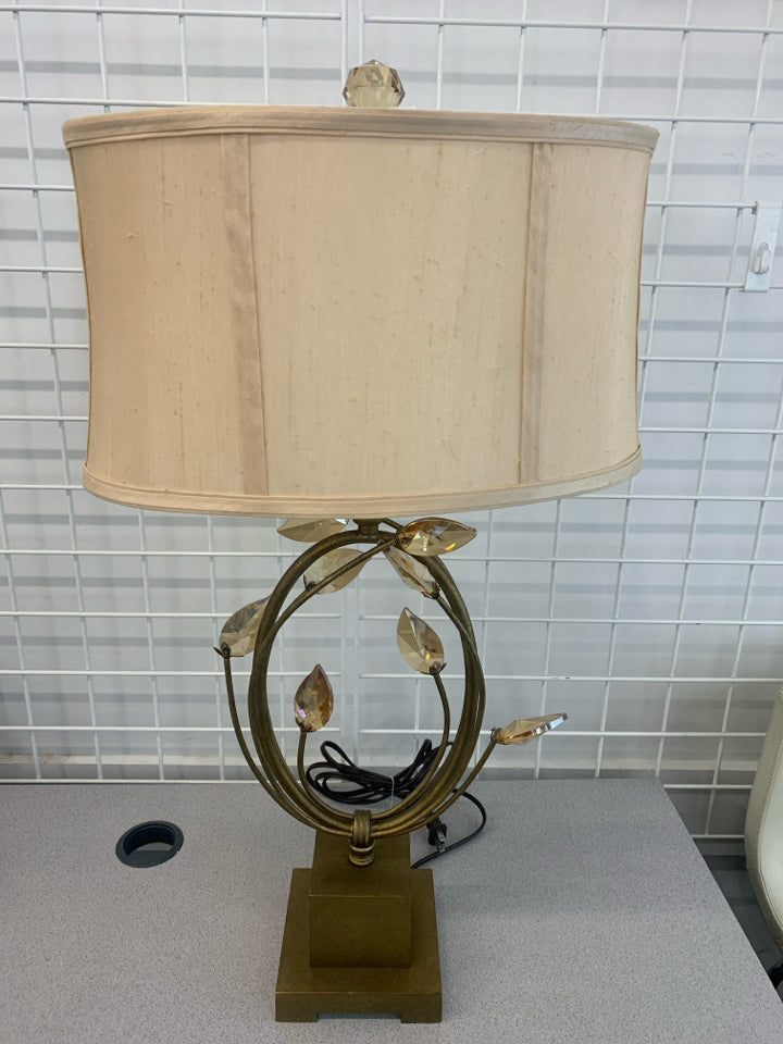 GOLD BASE LAMP W/CRYSTAL LEAVES AND CREAM SHADE.