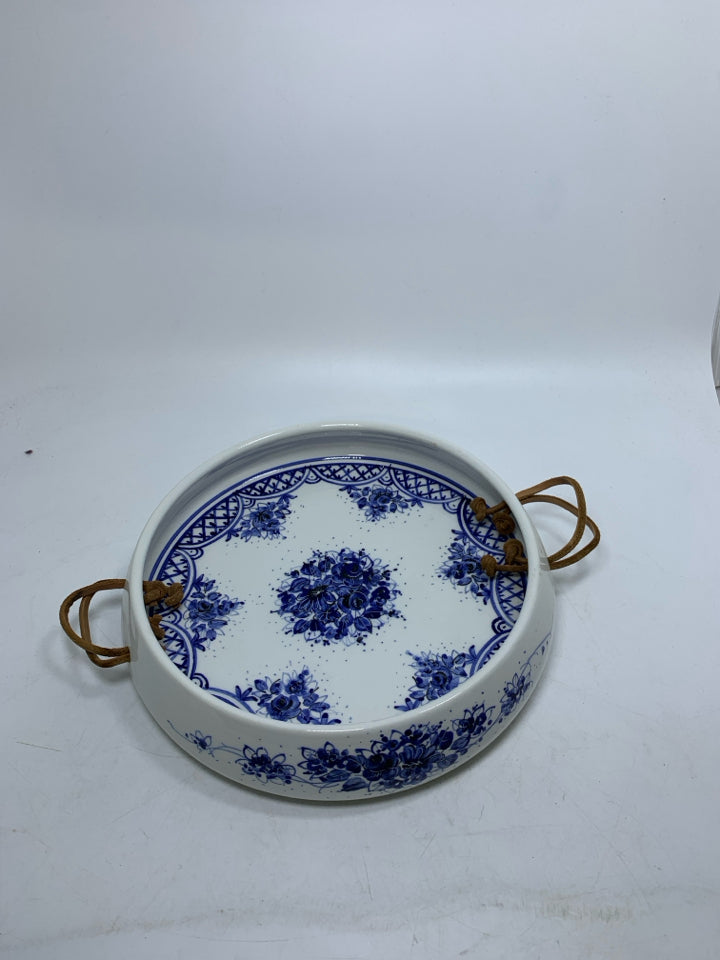WHITE DEEP CERAMIC TRAY W/ BLUE FLORAL DESIGN LEATHER HANDLES.