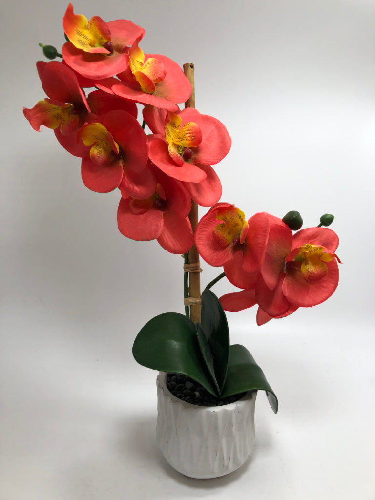 FAUX ORANGE ORCHIDS IN WHITE VASE.