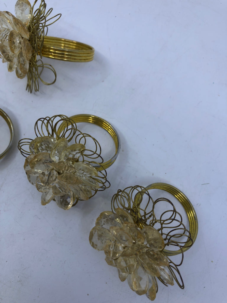 4 GOLD NAPKIN RINGS W/CRYSTAL GEMS.