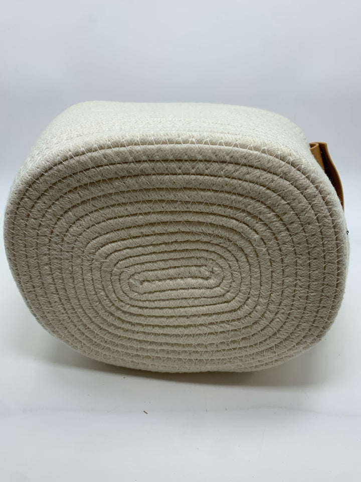 WHITE CLOTH BASKET W/LEATHER HANDLES.