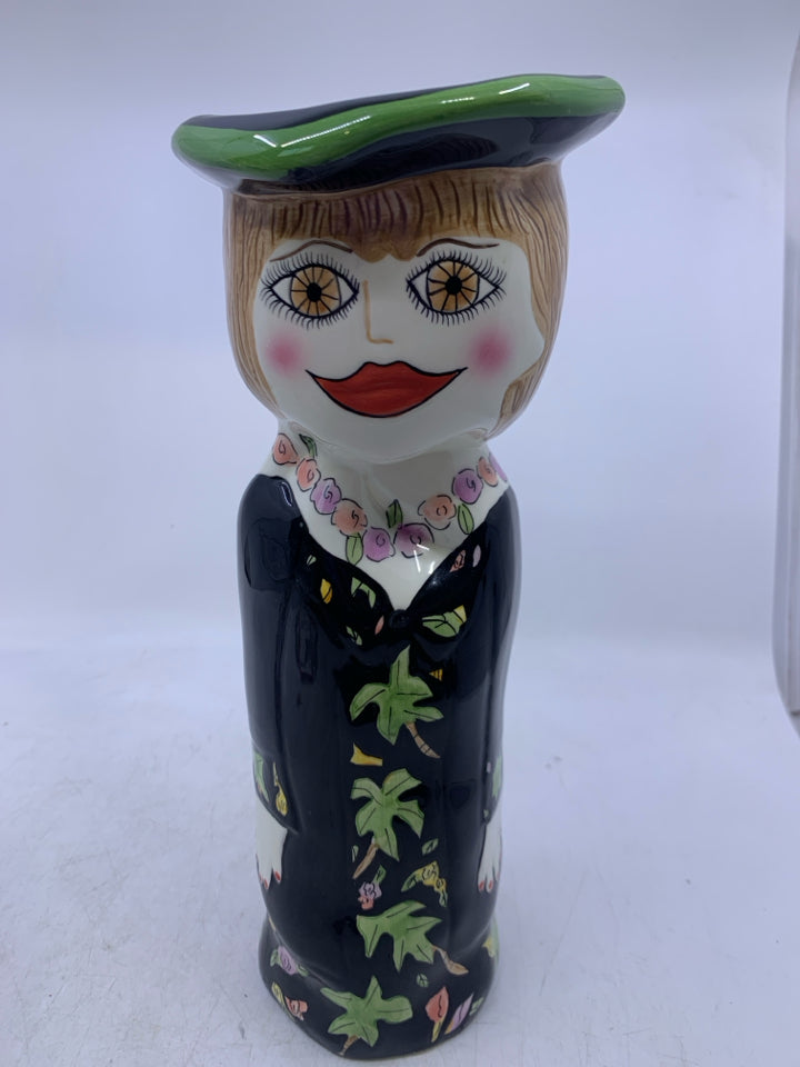 WOMAN SHAPED VASE W/ BLACK DRESS FLOWER NECKLACE.