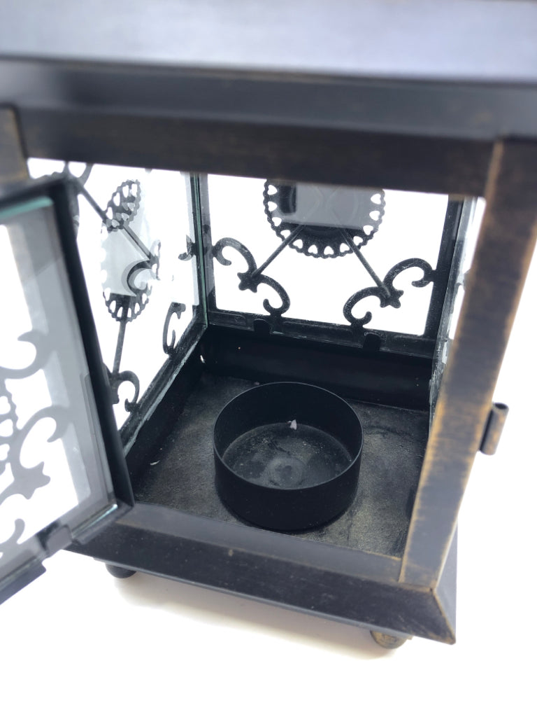 SMALL LANTERN W/ GLASS PANES JEWELS IN MIDDLE PIERCED TOP.