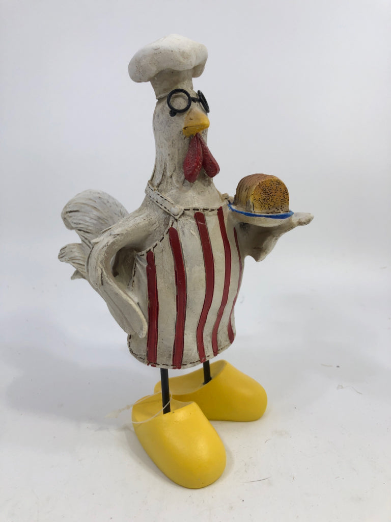 CHICKEN CHEF HOLDING BREAD W/LARGE SHOES.