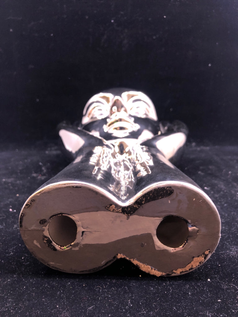 CERAMIC SILVER PERSON HOLDING UP THEIR FACE.