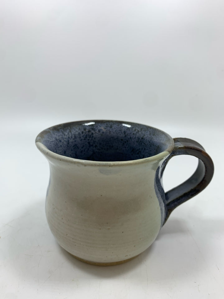 BLUE/WHITE GLAZED POTTERY MUG.