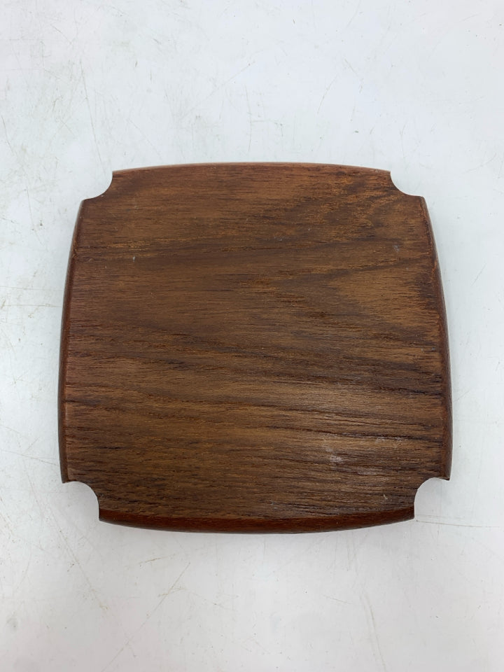 6 CARVED WOODEN COASTERS IN HOLDER.