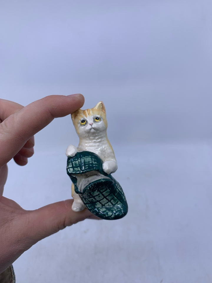 PORCELAIN CAT WITH SLIPPER.
