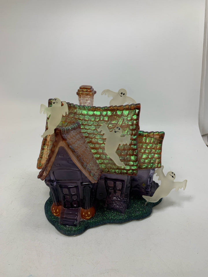 PLASTIC/RESIN PURPLE GHOST HAUNTED HOUSE W/ MUSIC/ FLSHING LIGHTS.