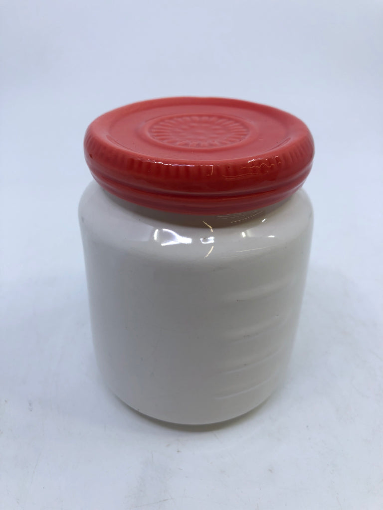 SMALL WHITE AND BLACK CANISTER W/ RED LID.