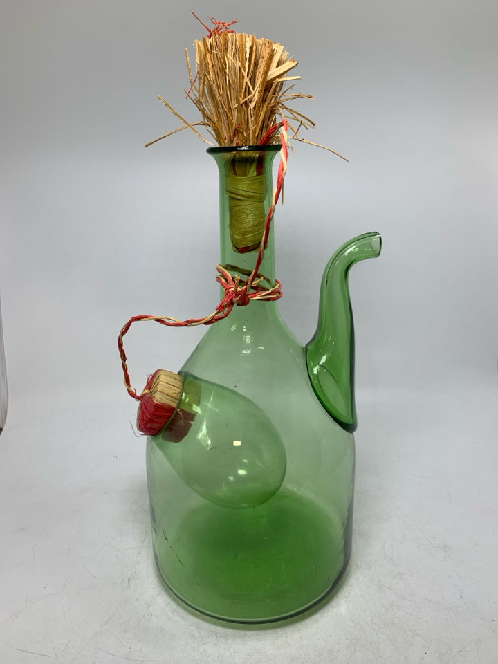 GREEN GLASS 2 COMPARTMENT DECANTER W/ WOVEN STOPPER.