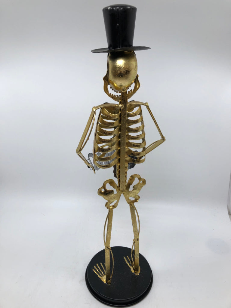 GOLD SKELETON SCULPTURE WITH TOP HAT AND ACCORDION.