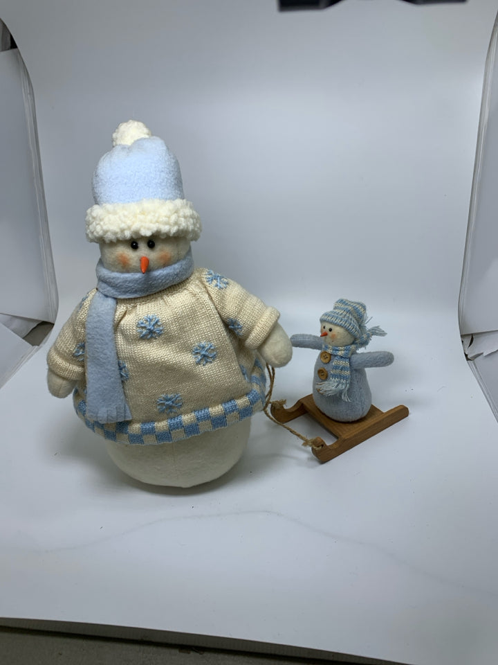 PLUSH WEIGHTED SNOWMAN PULLING BABY.