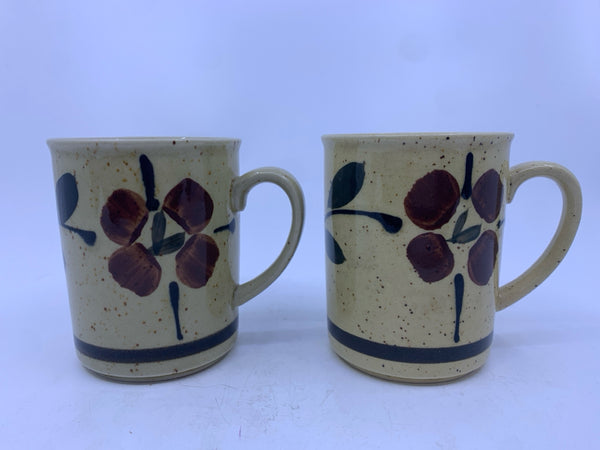 2 TAN WITH BROWN FLORAL AND SPECKLED MUGS.