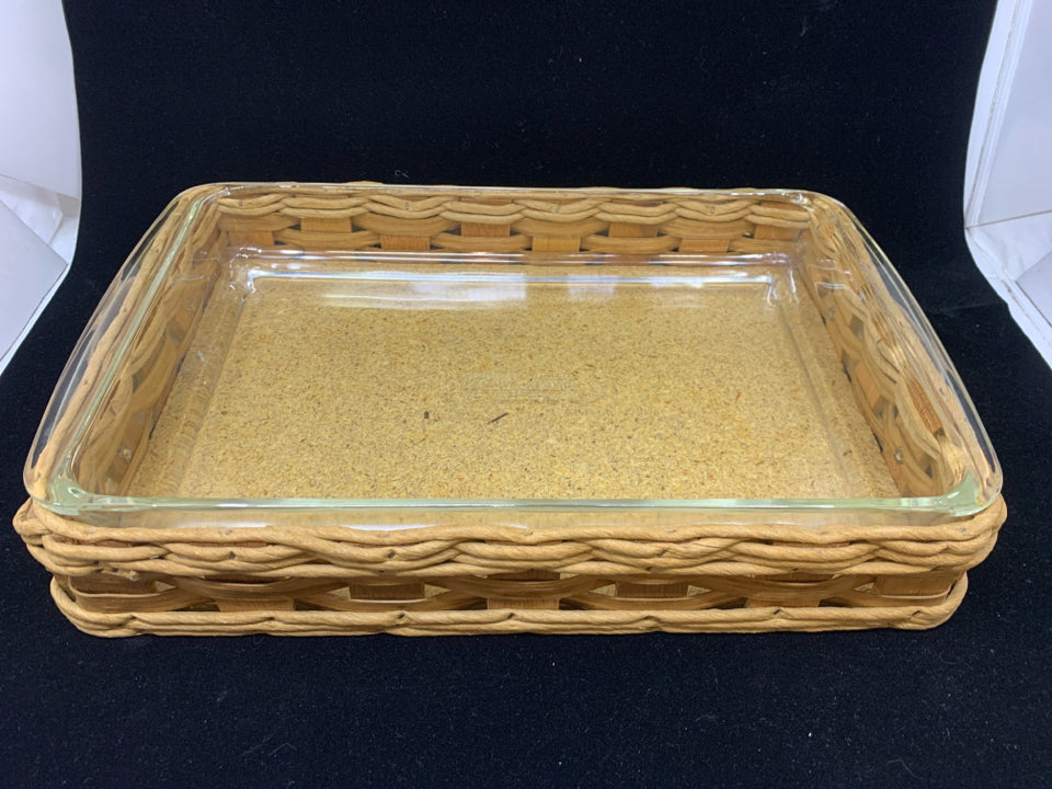PYREX DISH W/WOVEN BASKET LEATHER HANDLES.