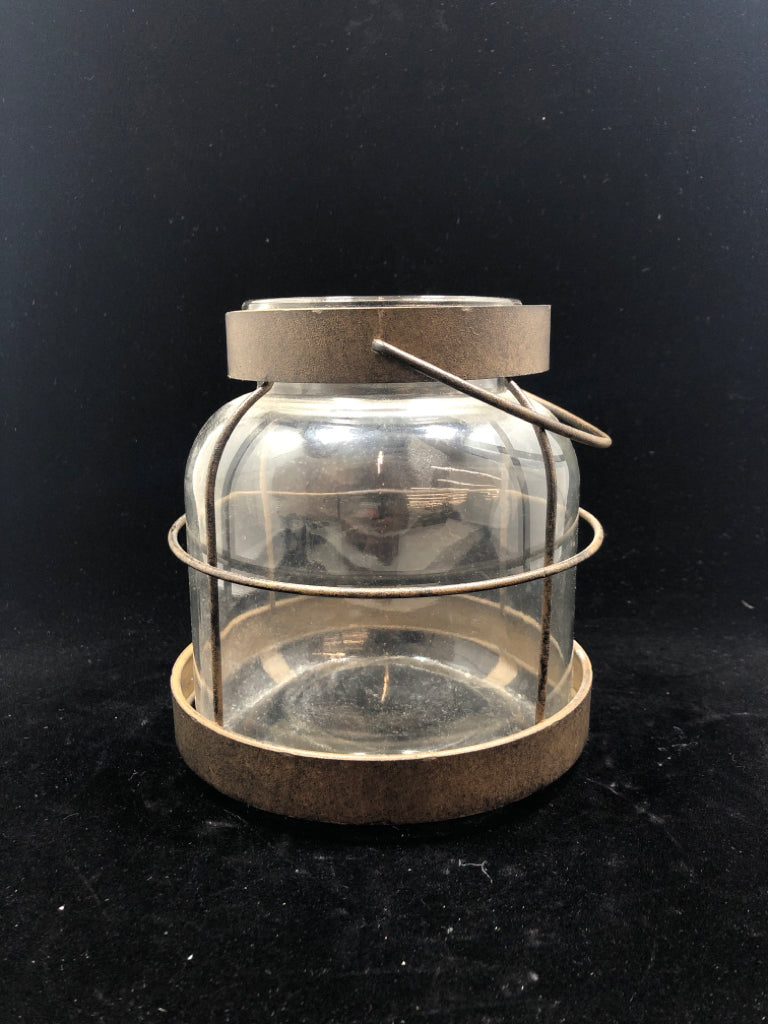 METAL WRAPPED GLASS CANDLE LANTERN.