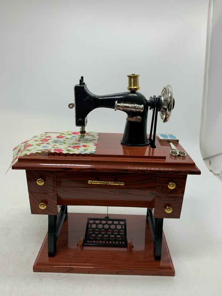 PLASTIC SEWING TABLE W/ MACHINE MUSIC BOX MOVING PIECES.