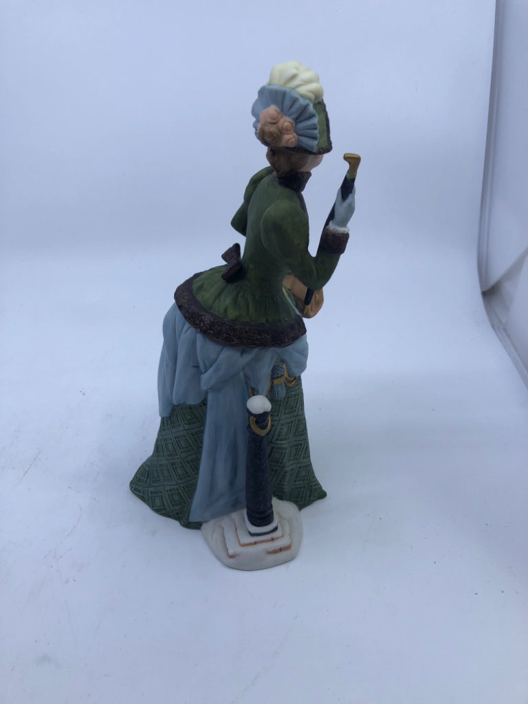 WOMAN IN GREEN DRESS W UMBRELLA- AVON 1987 ALBEE AWARD.
