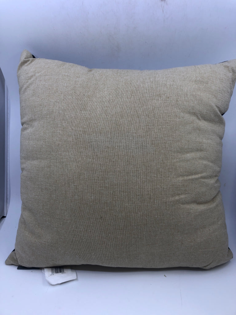 BLACK AND TAN PILLOW.