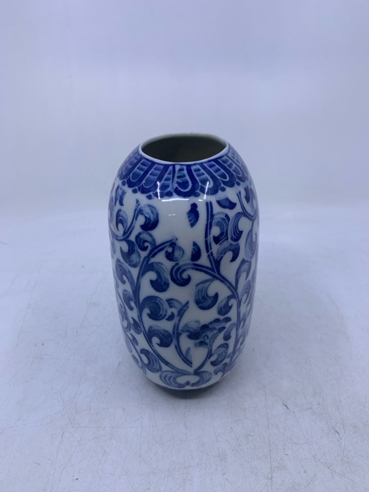 WHITE W/ BLUE FLORAL OVAL CERAMIC VASE.