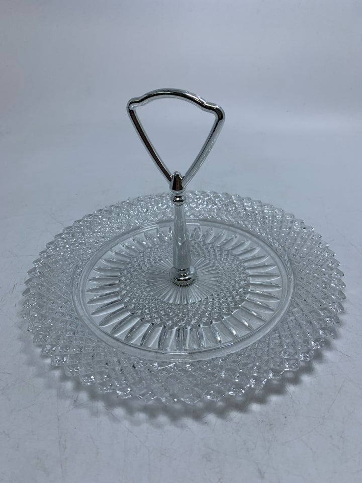 GLASS PLATE W/ METAL HANDLE IN CENTER.