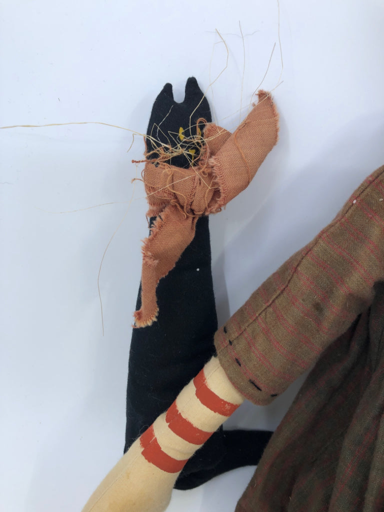 PRIMITIVE PUMPKIN MAN HOLDING BLACK CAT.