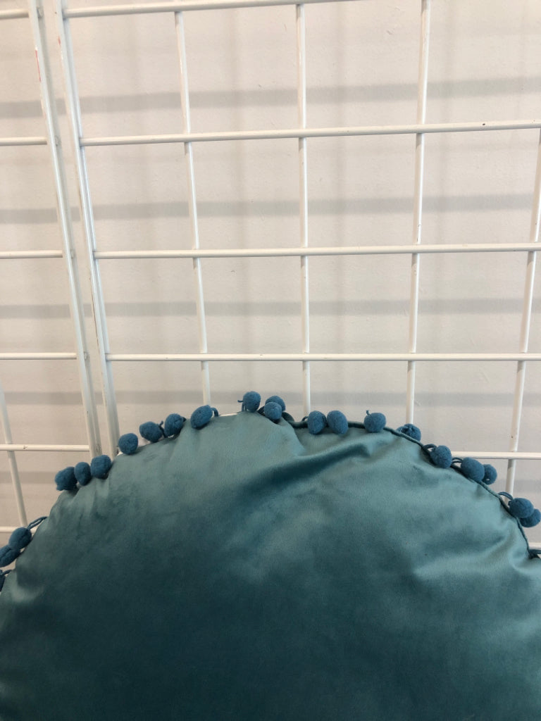 ROUND BLUE PILLOW W/POM POMS.