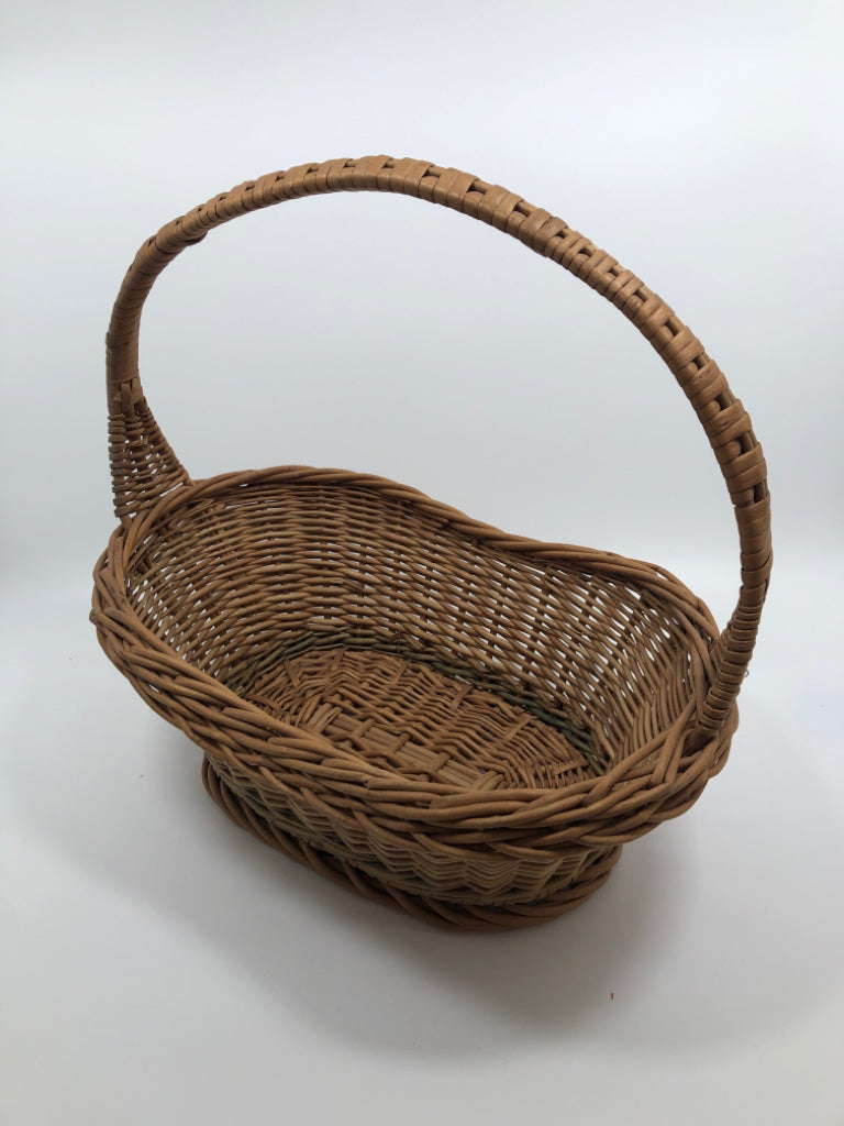 BROWN OVAL WICKER BASKET W/WOVEN HANDLE.