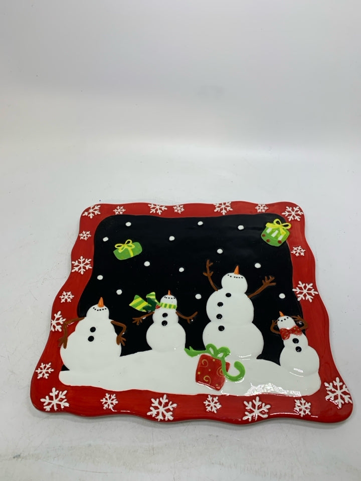 SQUARE CAKE STAND W/ EMBOSSED SNOWMEN THROWING PRESENTS IN AIR.