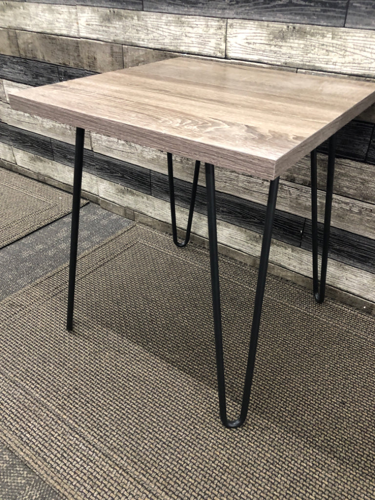FAUX GREY WOOD SIDE TABLE W/ BLACK METAL PIN HAIR LEGS.