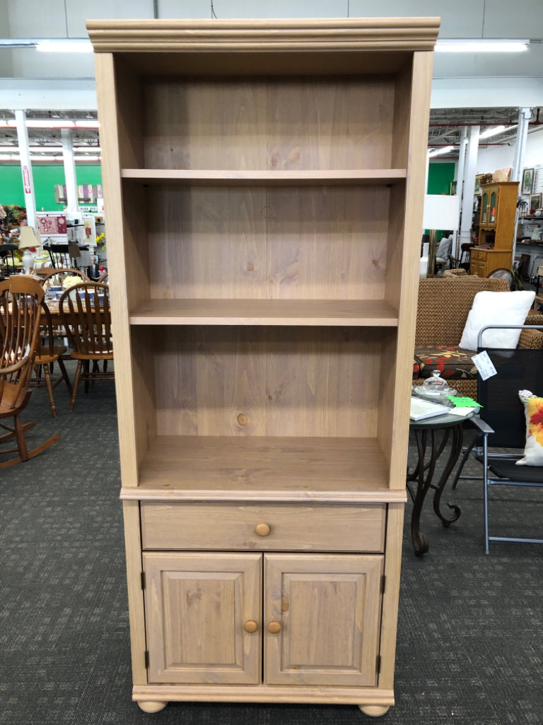 BLONDE WOOD LIBRARY SHELF W/DOORS.