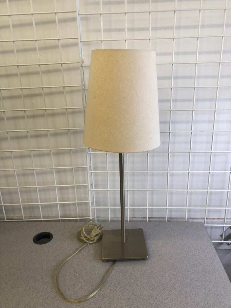 SILVER SKINNY BASE LAMP W/ OFF WHITE SHADE.