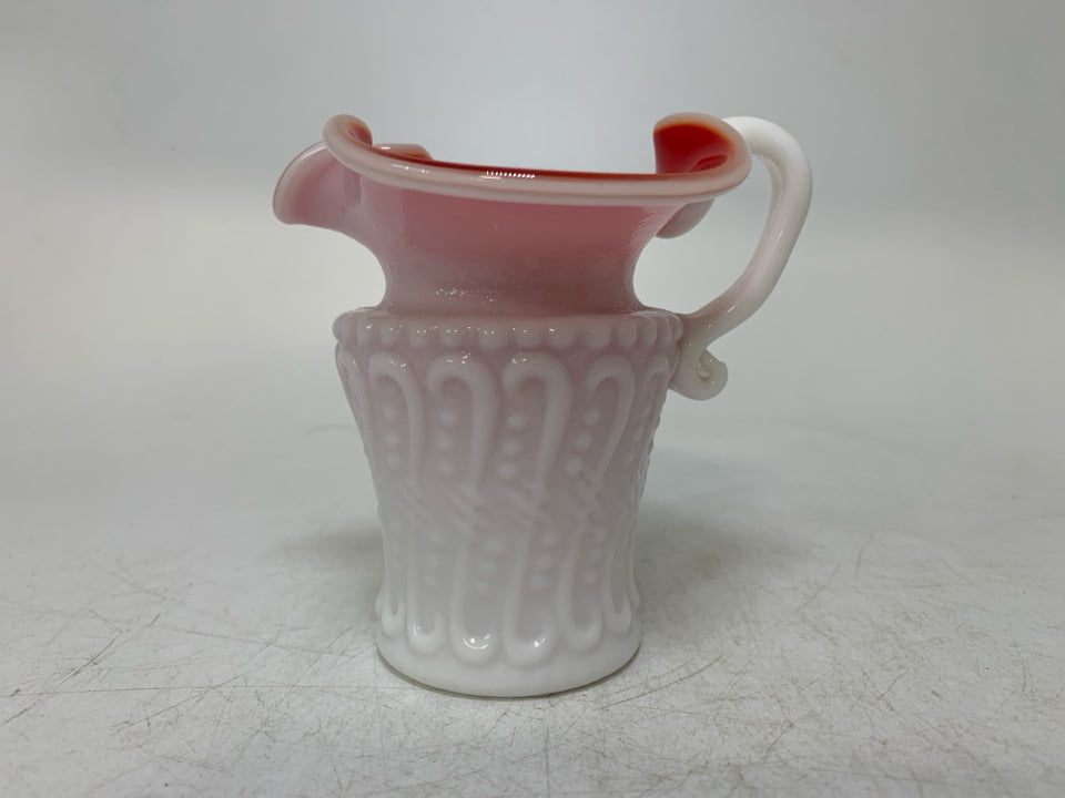 TEXTURED MILK GLASS W/ RED INTERIOR PINCHED SPOUT CREAMER.