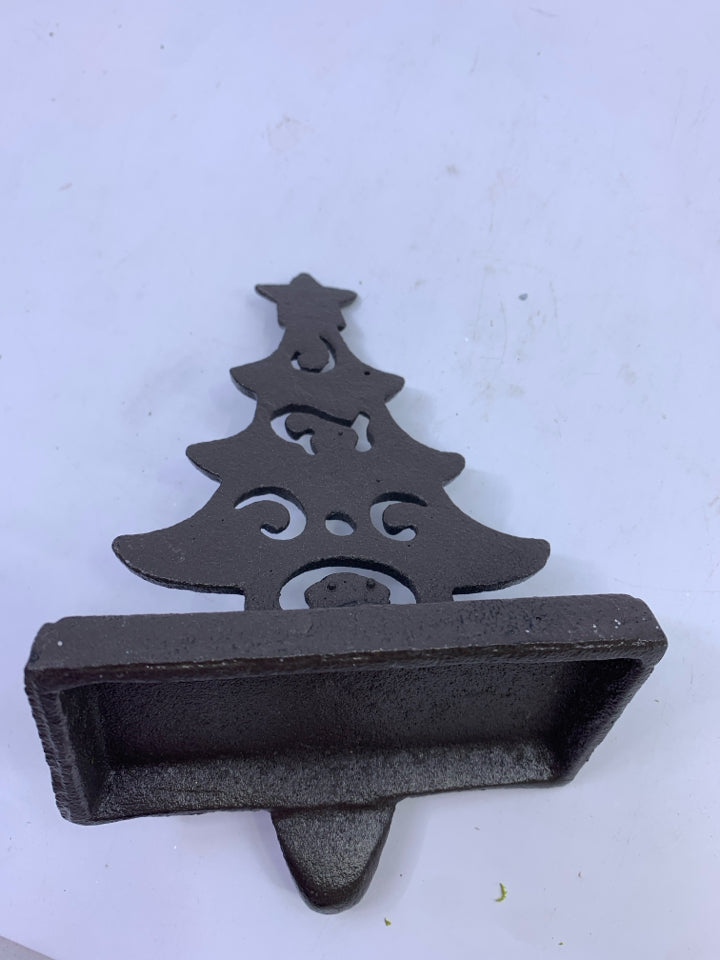 BROWN METAL CUTOUT TREE STOCKING HOLDER.