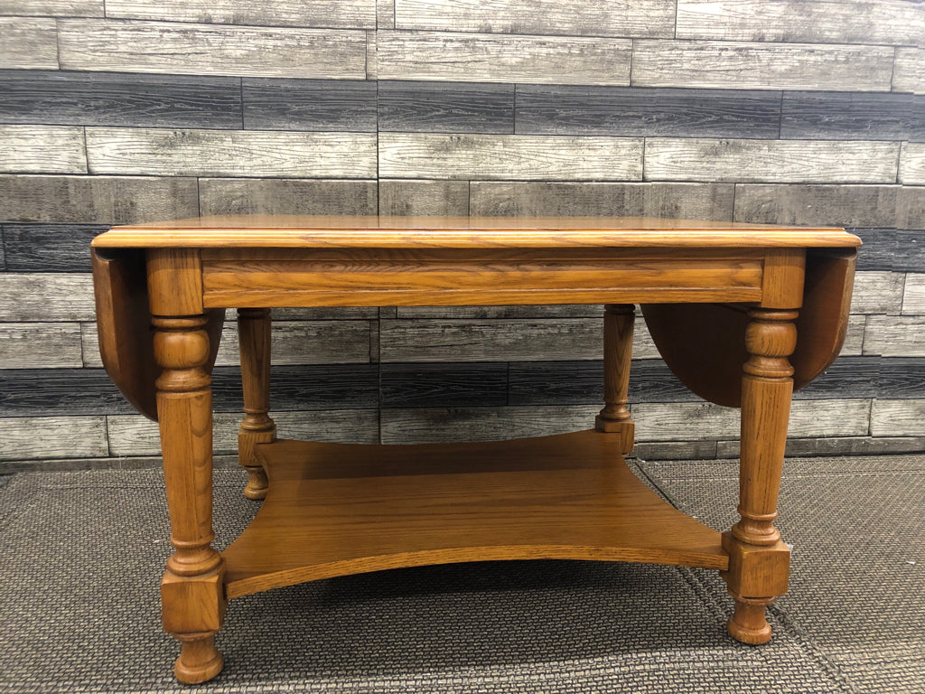 SOLID WOOD 2 TIER COFFEE TABLE W/ 2 DROP LEAF ENDS.