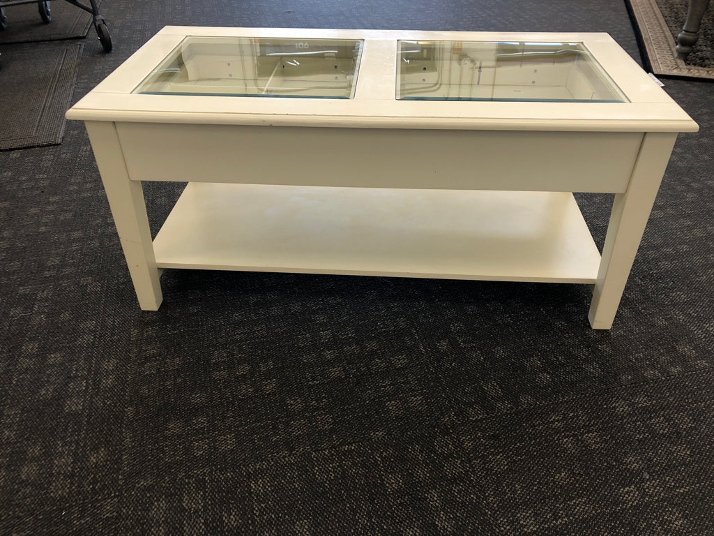 CREAM COFFEE TABLE W GLASS TOP AND 2 DRAWERS.