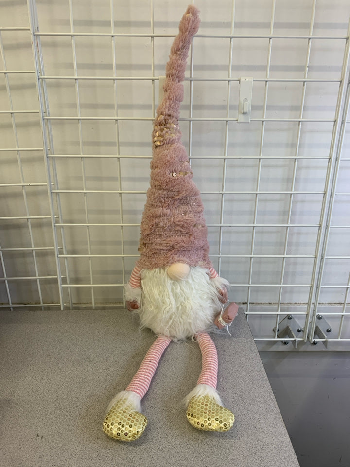 PINK HAT GNOME HOLDING PRESENT, GOLD SHOES.