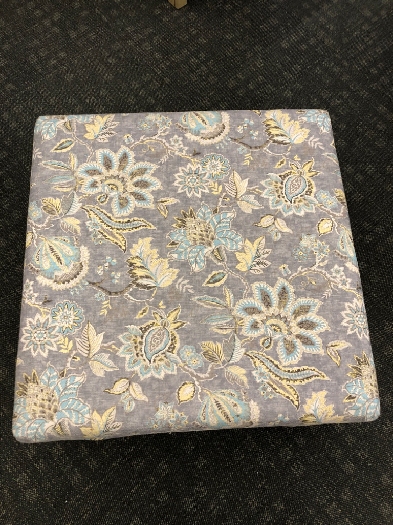 GREY FLORAL UPHOLSTERED OTTOMAN.