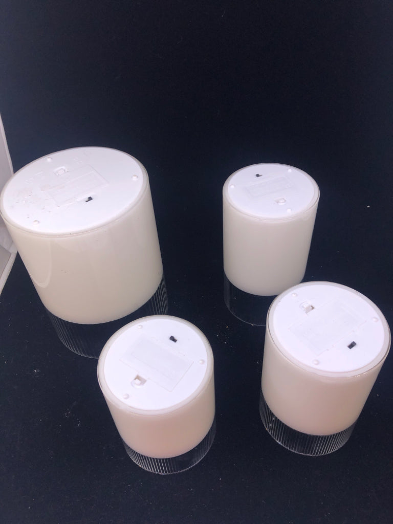 4 LIGHT UP PILLAR GLASS CANDLES.