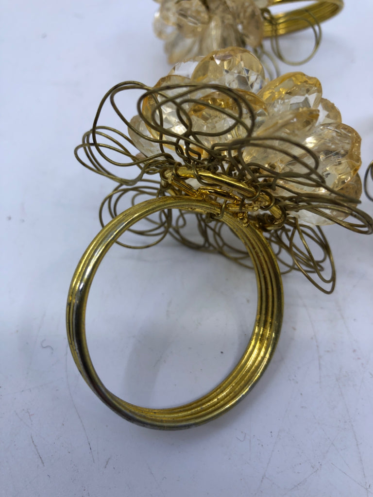 4 GOLD NAPKIN RINGS W/CRYSTAL GEMS.