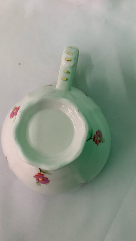 LIGHT BLUE W PINK FLORAL TEACUP AND SAUCER.