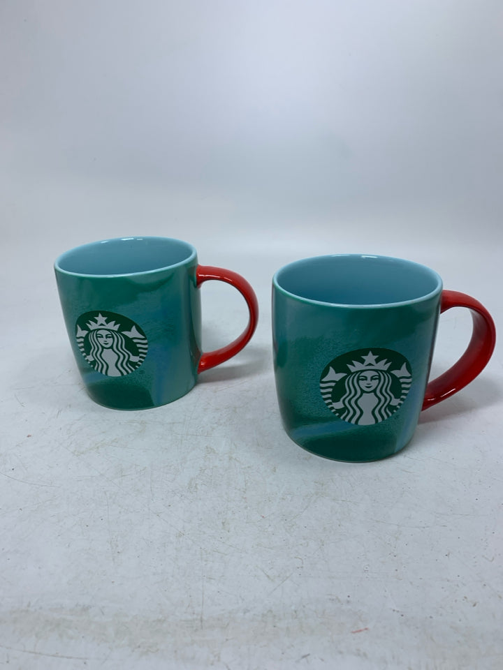 2 GREEN MARBLE MUGS W/ RED HANDLES.