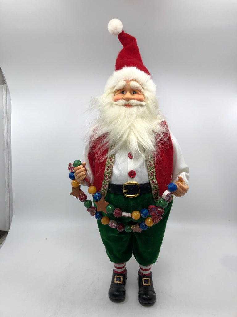 STANDING SANTA HOLDING GARLAND W/ RED VEST.