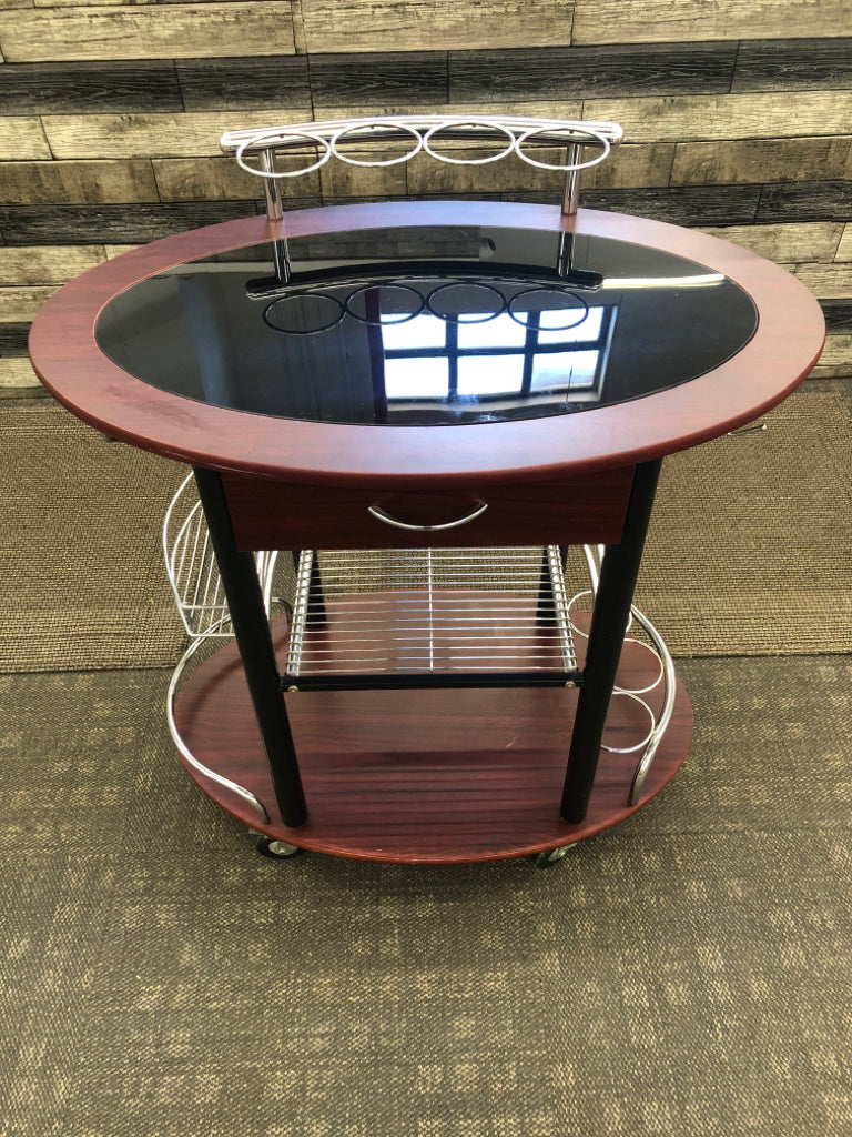 DK WOOD OVAL ROLLING BAR CART W/BLACK GLASS TOP.