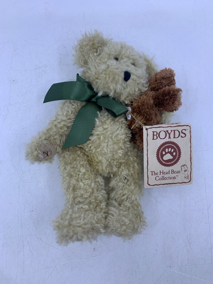 SMALL BEIGE SHAG BEAR HOLDING BROWN BEAR.