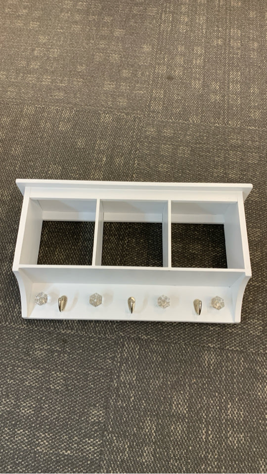 WHITE WOOD WALL SHELF W/3 CUBBIES AND HOOKS.