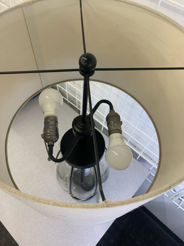 GLASS BASE LAMP W/TAN SHADE.